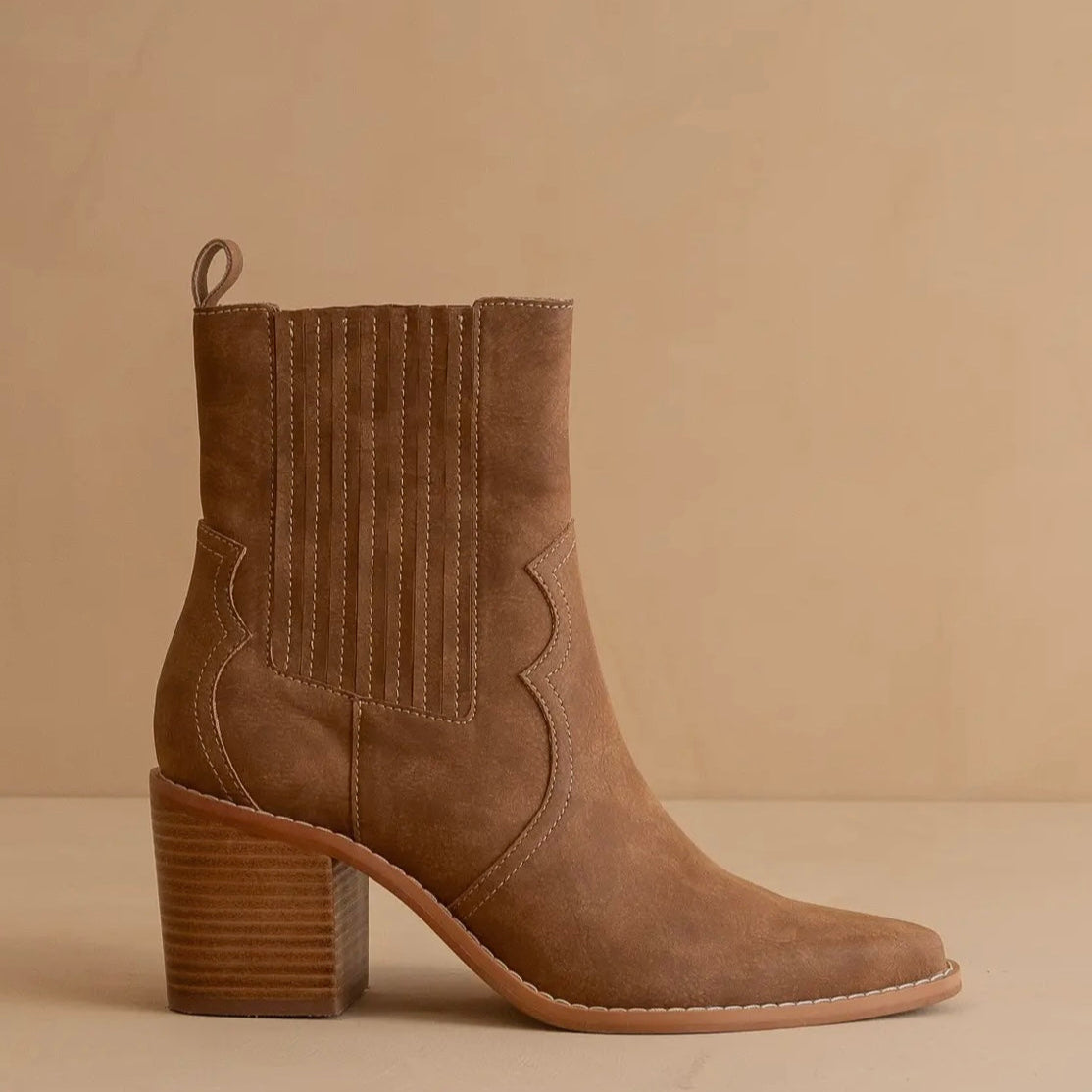 Brown suede ankle boot on a beige background