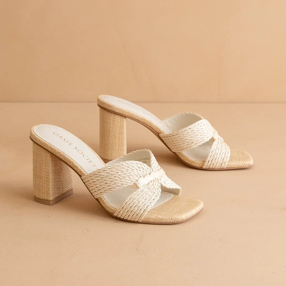 Woven sandals with a block heel on a beige background