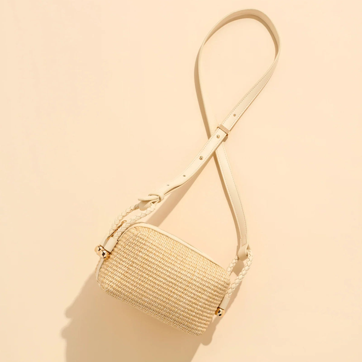 Beige woven handbag on a beige background