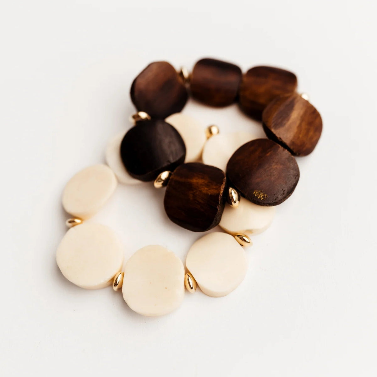 Bracelet with wooden and cream-colored beads on a white background