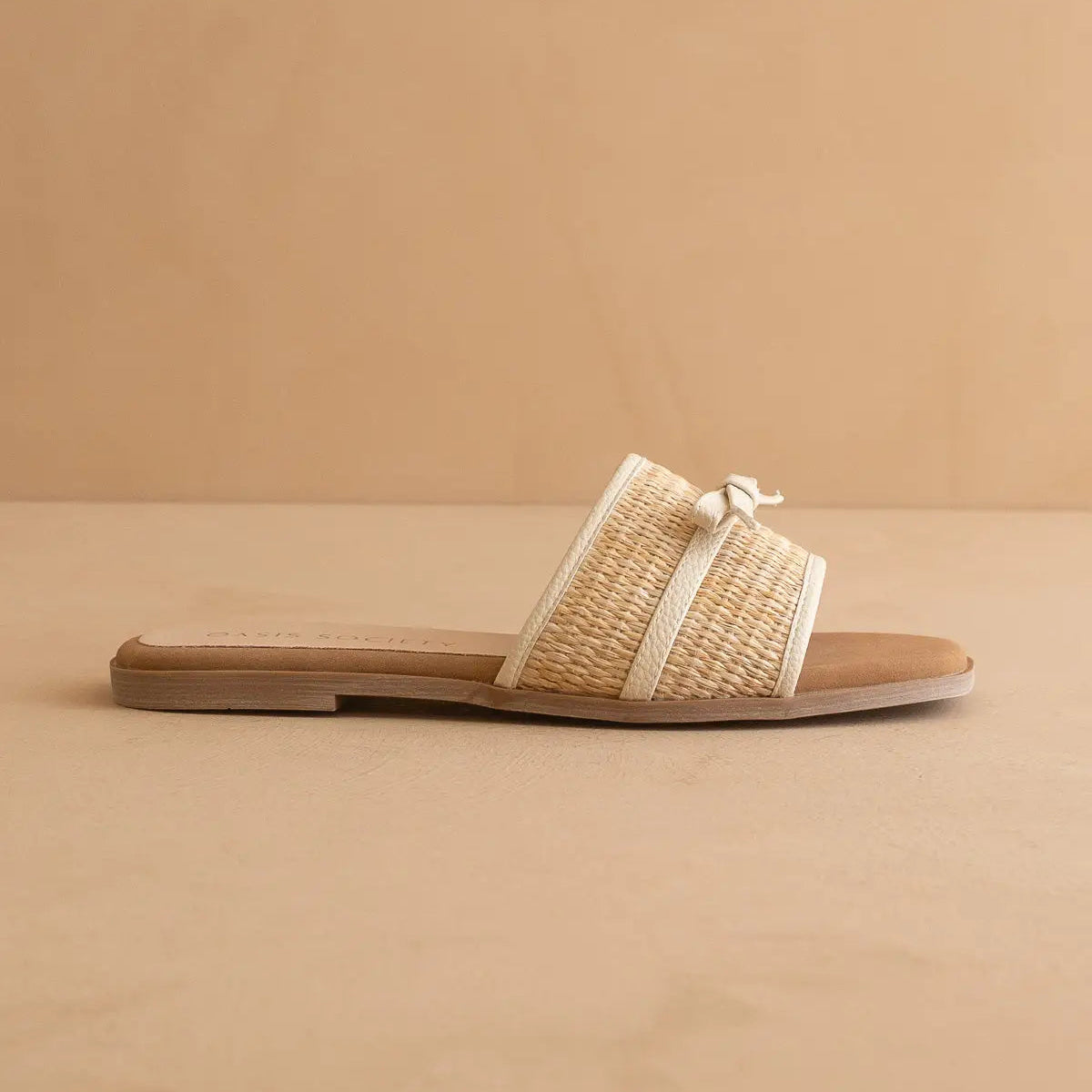 Woven sandal with a ribbon on a beige background