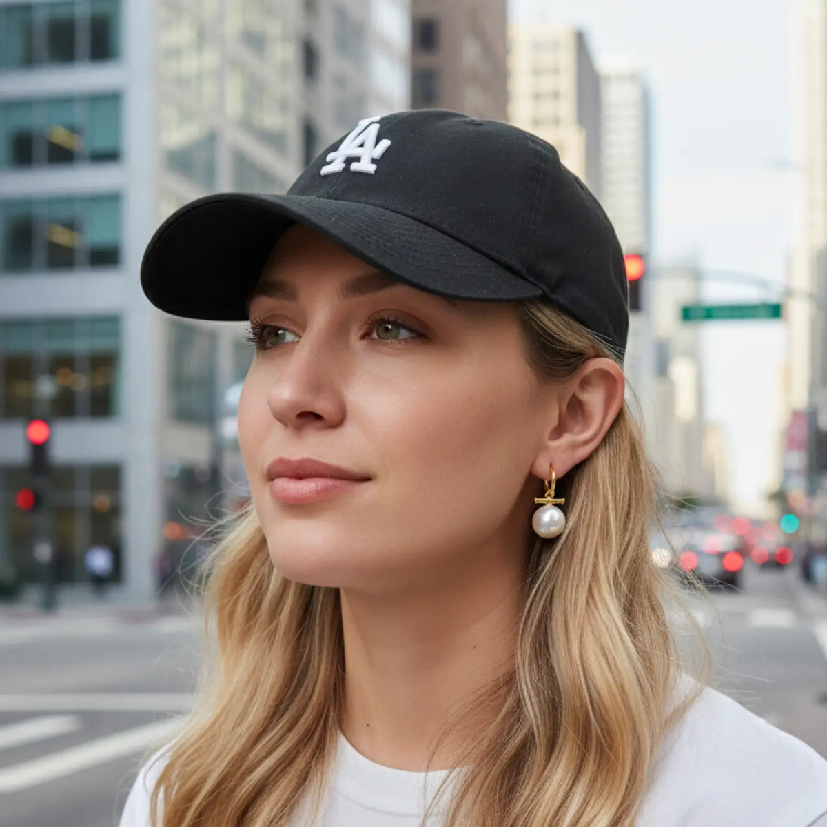 Woman wearing a black cap with a logo in an urban setting