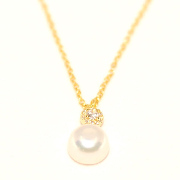 Pearl necklace with gold chain on a white background