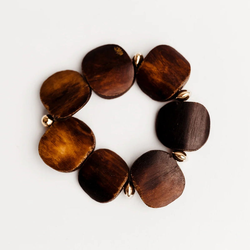 Wooden bracelet with round brown beads on a white background