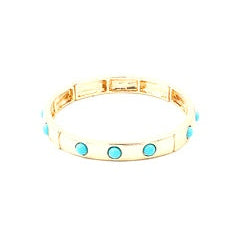 Gold bracelet with turquoise stones on a white background