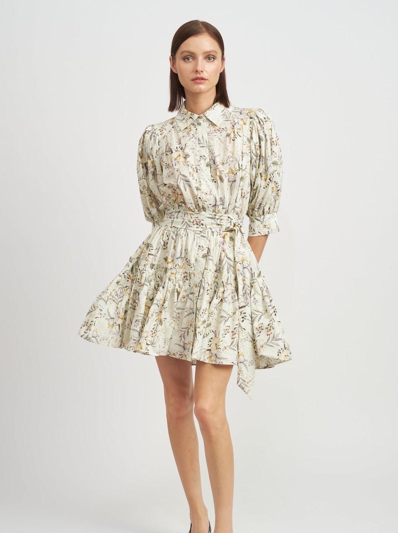 ivory mini dress with ruffle hem, collar and puff sleeves and tie at waist.  Ivory, green and yellow floral