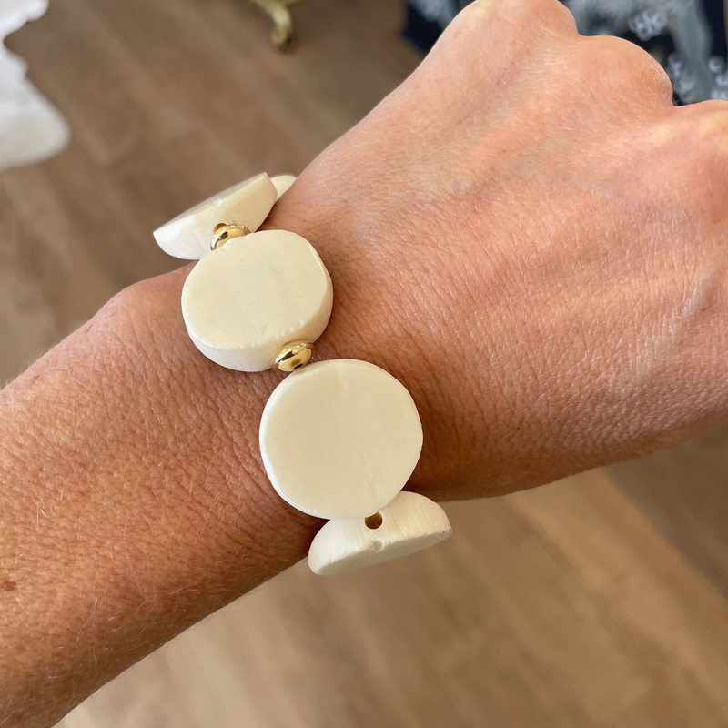 Beige bracelet on a wrist with a blurred background