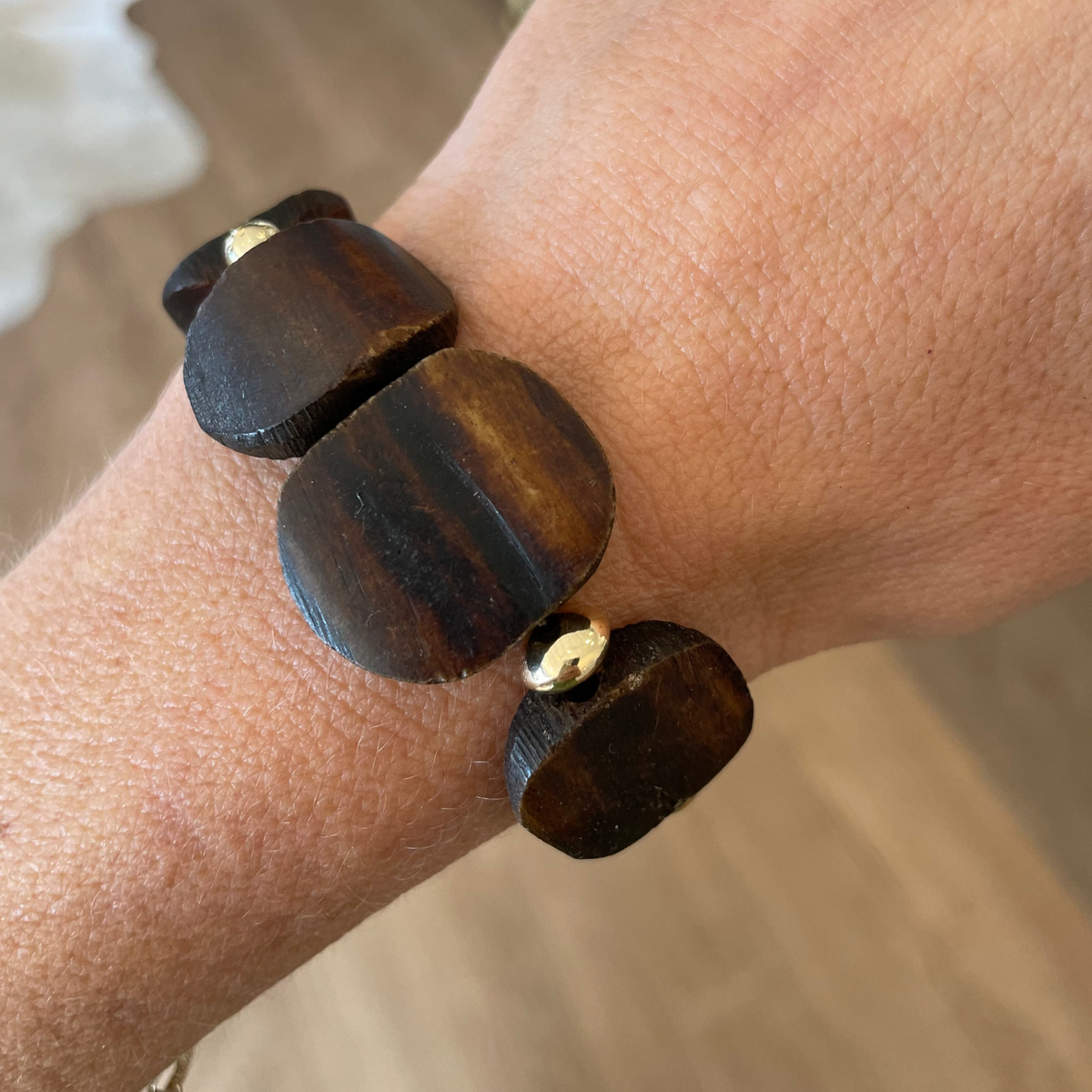 Wooden bracelet on a wrist with a blurred background