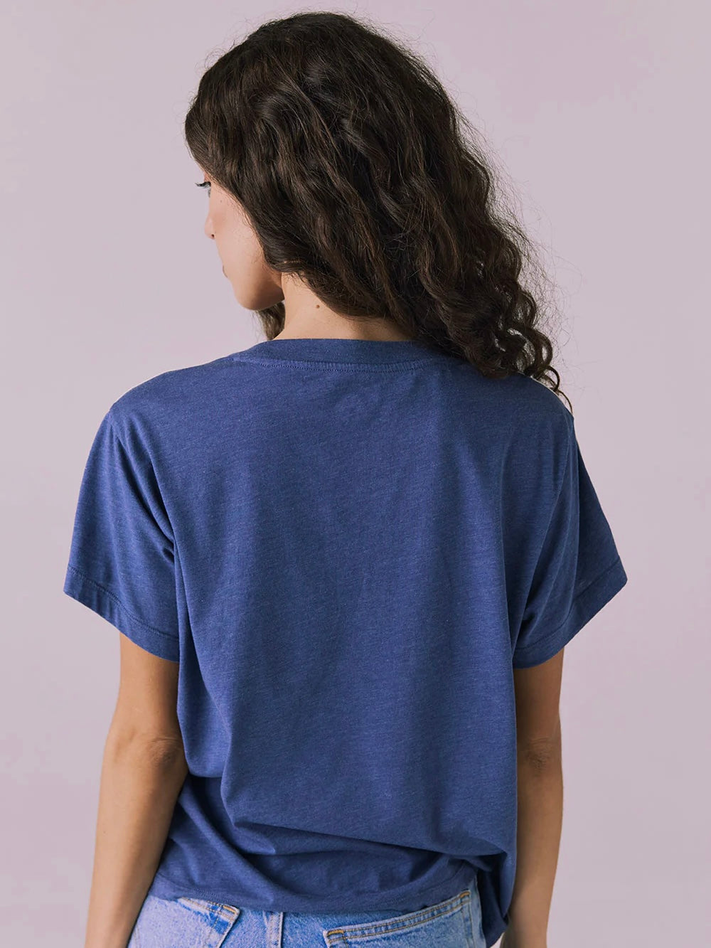 Person wearing a blue t-shirt against a plain background