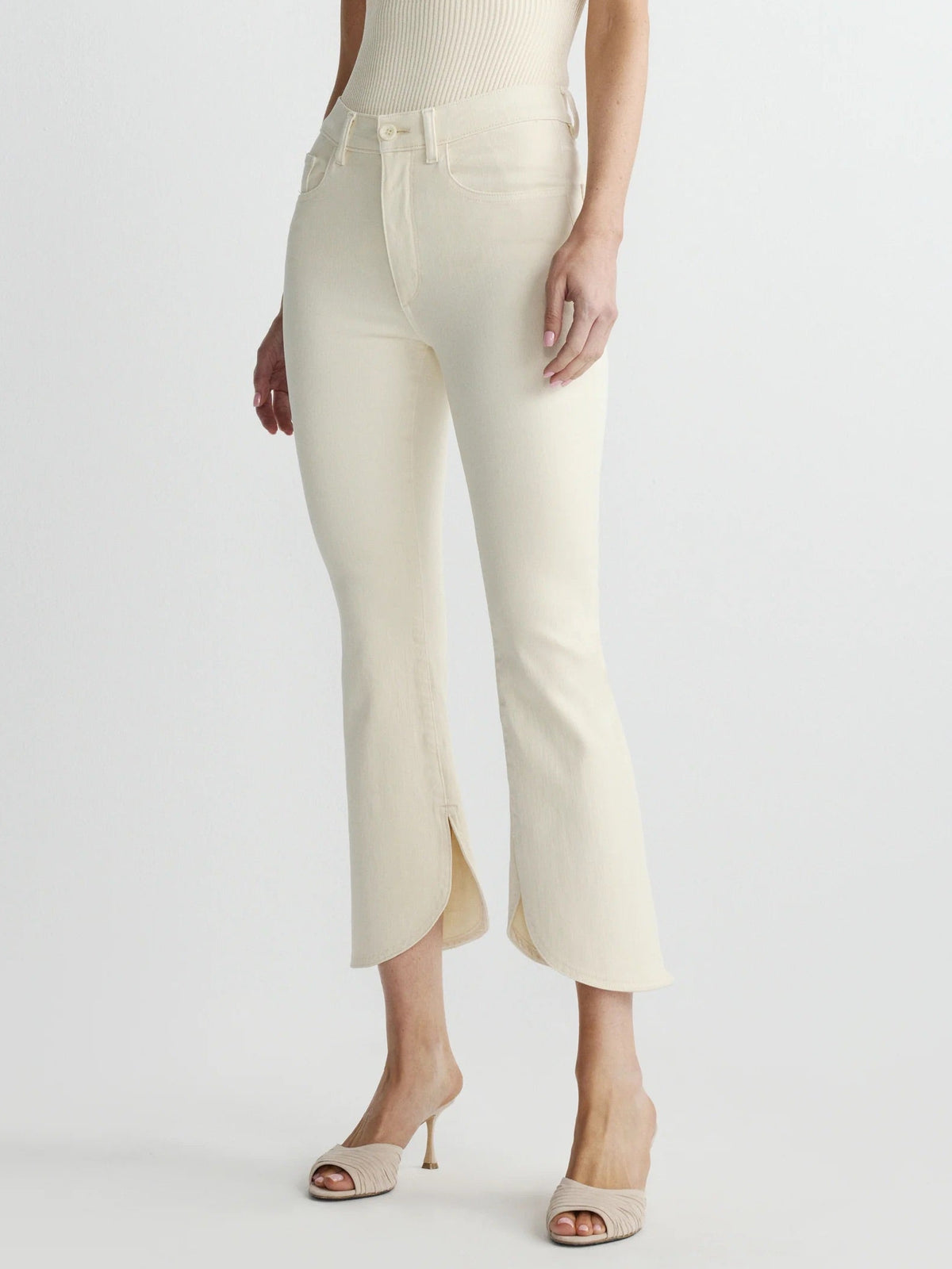 Woman wearing a cream-colored outfit on a white background