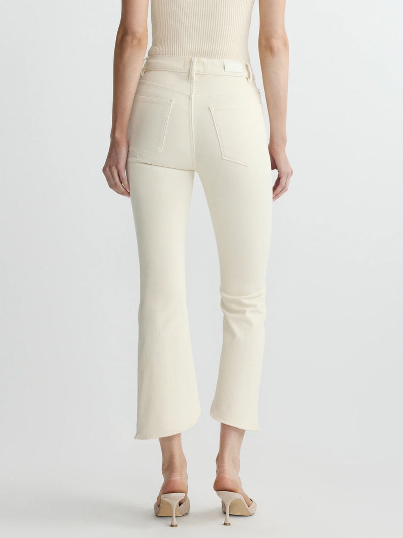 Person wearing a cream-colored top and pants on a white background