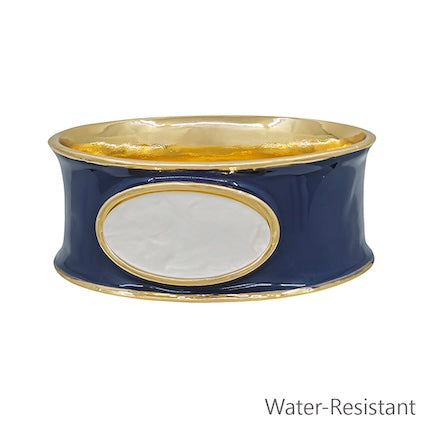 Navy blue bracelet with gold accents on a white background