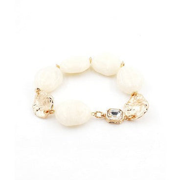 White beaded bracelet with gold accents on a white background