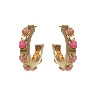 Gold hoop earrings with pink stones on a white background