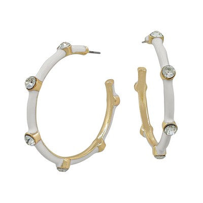 Pair of hoop earrings with white and gold design on a white background