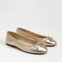 metallic gold ballet flat with bows and logo charms.