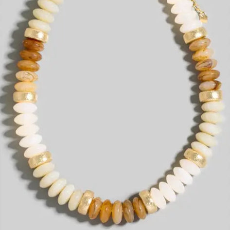 Necklace with multicolored beads on a gray background