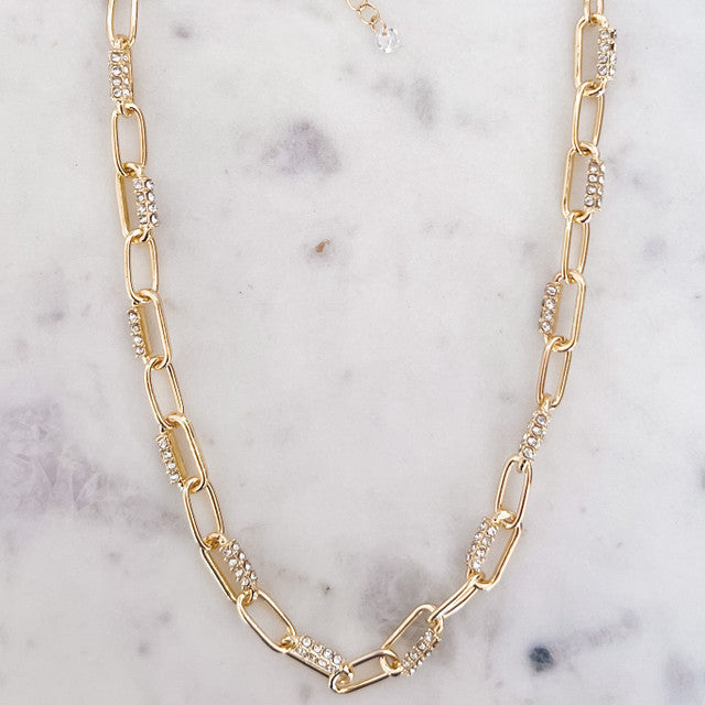 Gold chain necklace on a marble surface